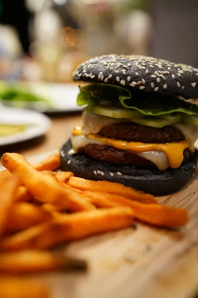 Black Burger Bun mit Pommes — Stockfoto