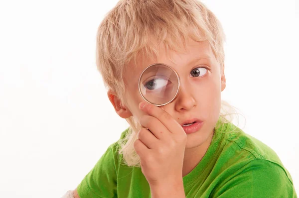 Child considers through magnifying glass world around — Stock Photo, Image