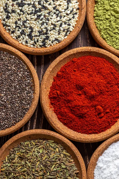 Multicolored food background made from powdered red pepper, chia seeds and sesame. Colors compatibility concept.