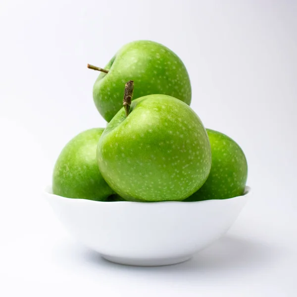 Green Apples White Plate White Backdrop Stock Image