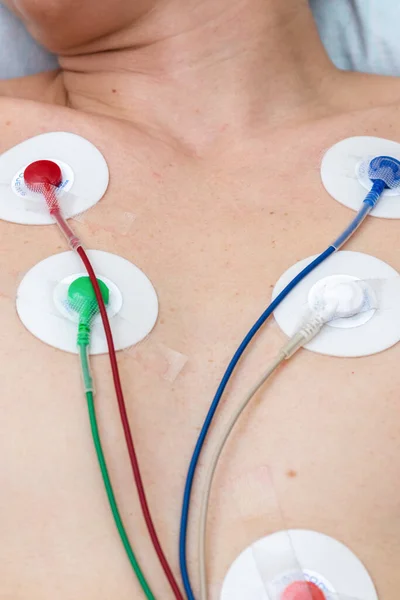 Hastanede tıbbi muayene prosedürünün dikey fotoğrafçılığı. Elektrokardiyografi elektrotlu göğüs..