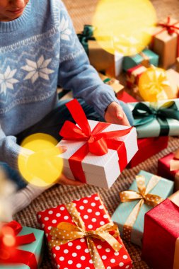 High angle view of female holding Christmas gift box indoors at home.