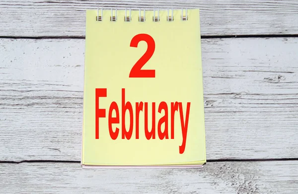 February 2. Groundhog Day, calendar in a notebook on a wooden background — Stock Photo, Image