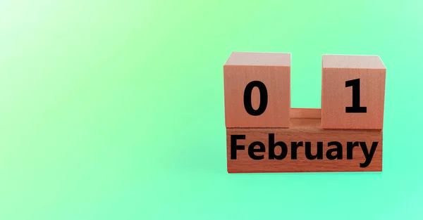 Calendario de bloques de madera con la fecha 01 de febrero en un fondo de vacaciones degradado verde con una copia del espacio y el espacio para su texto — Foto de Stock