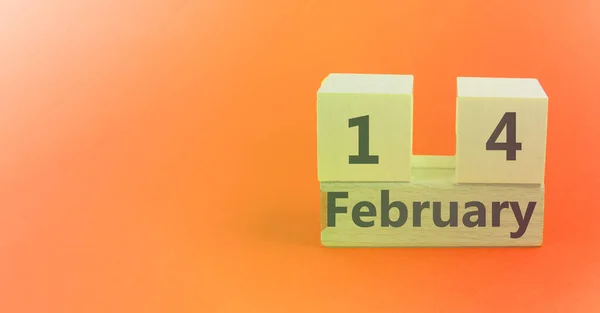 Gradient light orange pink background with wooden block calendar with date February 14 with copy space and space for your text — Stock Photo, Image