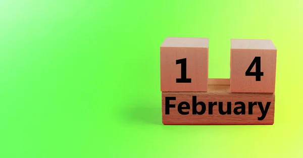 Gradient light green background with wooden block calendar with date February 14 with copy space and space for your text — Stock Photo, Image