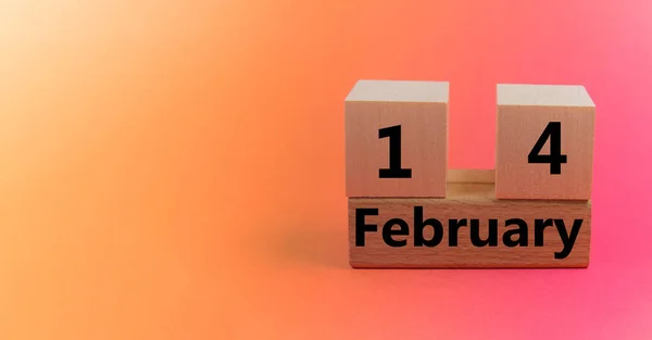 Gradient light orange pink background with wooden block calendar with date February 14 with copy space and space for your text — Stock Photo, Image