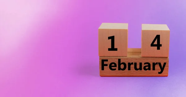 Lutande rosa bakgrund med träblock kalender med datum 14 februari med kopieringsutrymme och utrymme för din text — Stockfoto