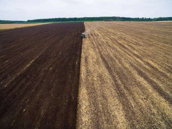 Harvesting in the field. Aerial view. Land cultivation with a tractor — Stock Photo, Image