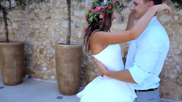 Beautiful bride and groom on their wedding day in the street of Greece. Slow motion. — Stock Video