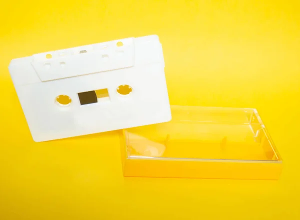Audio tape. Vintage white audio tape with yellow background.