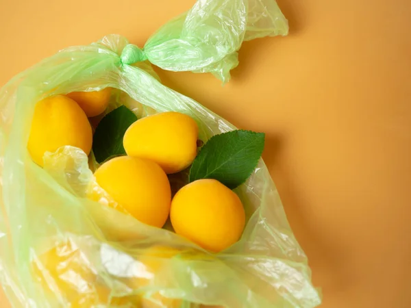 Fresh Apricots Torn Plastic Bag — 图库照片