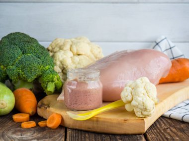 baby puree from fresh zucchini, poultry and broccoli in a jar. baby food.