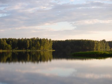 landscape with reflection in the water . Beautiful sunset over a calm lake After sunset, the sky is reflected in the water