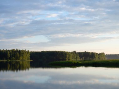 landscape with reflection in the water . Beautiful sunset over a calm lake After sunset, the sky is reflected in the water