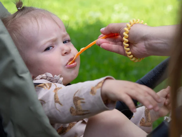 Young Mother Feeds Baby Street Stroller Spoon Jar Mashed Potatoes — Stok fotoğraf