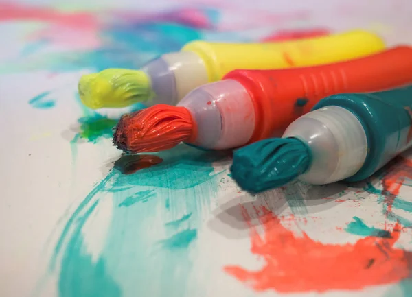 kid colored markers with brush stroke lines on painted white paper background Macro Selective focus