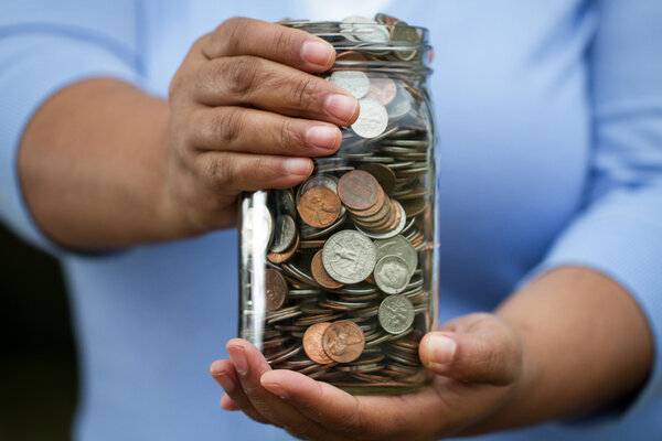 Woman holding jar of money