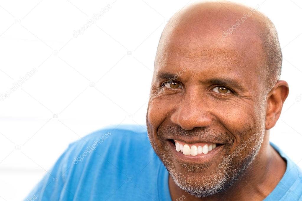 Mature African American man smiling isolated on white.