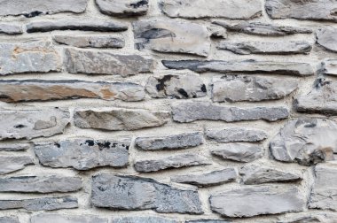 Taş bir duvarın dokusu. Eski kale taşından duvar dokusu. Bir taş duvarın parçası, arkaplan veya doku için