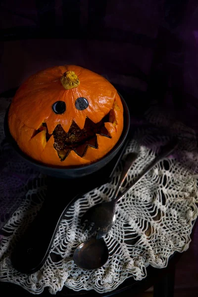Halloween Pumpkin head, pumpkin with teeth and eyes, selective focus, vertical photo in a dark key.