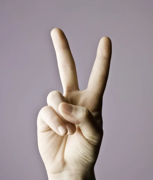 Man hand indicating peace victory sign Stock Image