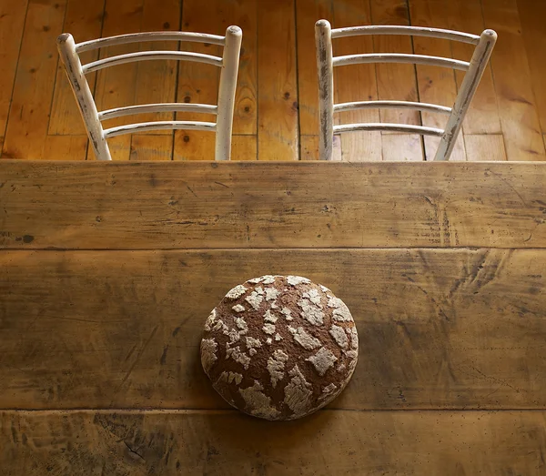 Loaf of bread on brown table — Stock Photo, Image