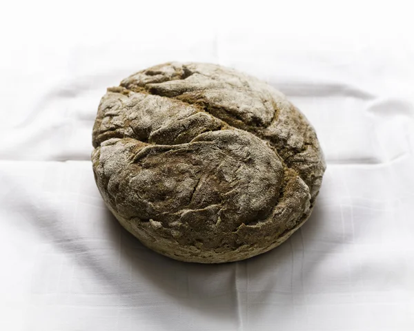 Rye loaf of bread still life on white table — Stok Foto