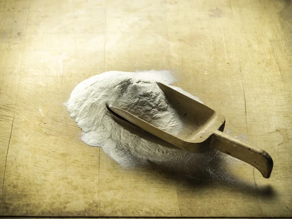 Still life with flour and wooden spoon — Stock Photo, Image