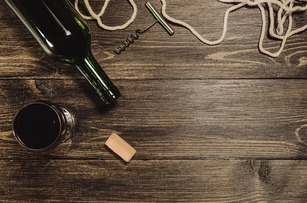 A bottle of wine on old wooden table — Stock Photo, Image