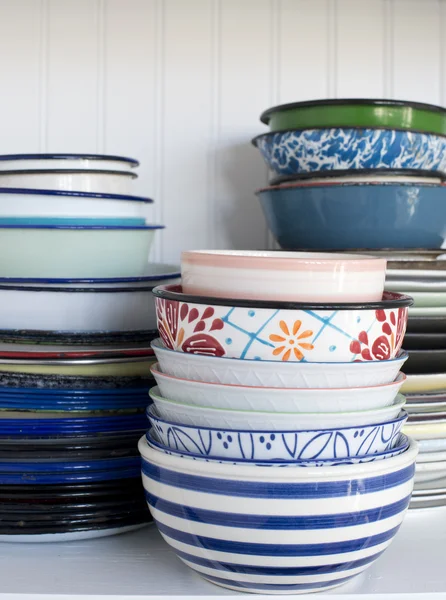 Pile of old dishes on a white shelf — Stock Photo, Image