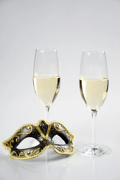 Glass of champagne and mask — Stock Photo, Image