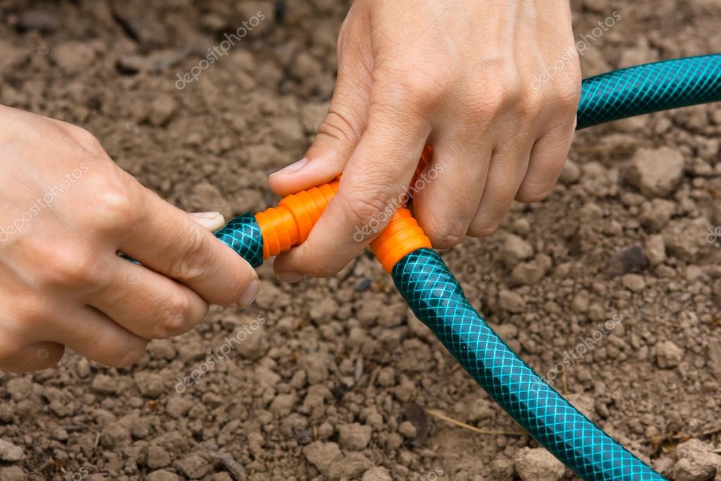 Hands connecting garden hoses for irrigation, closeup — Stock Photo