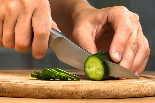 Manos rebanando pepino — Foto de Stock