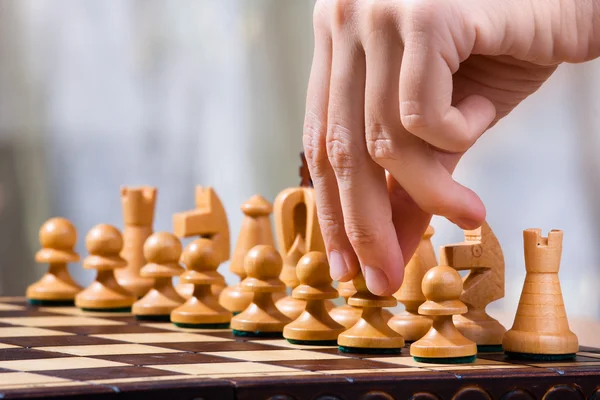 hand of chess player with pawn