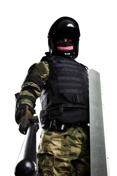 Soldiers in full uniform with armor, baton, protective shield. Uniform conforms to Police Special Purpose Mobile Unit (rosgvardia). Patch on the rude with the inscription Rosgvardia in Russian.