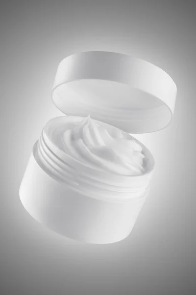 White blank packaging cosmetic cream jar. Shot in studio isolated on grey background with clipping path. Cosmetic product design template concept (flip image)