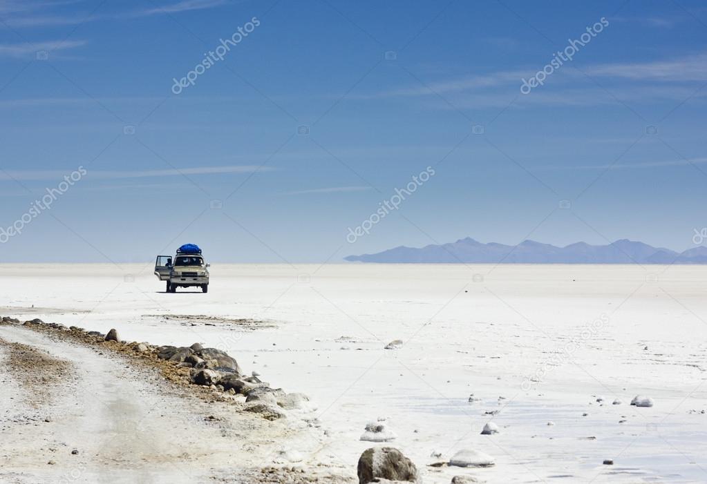 car in Salar de Uyuni on white surface