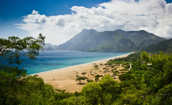 Lång strand som omges av berg — Stockfoto