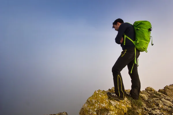 Mann steht bei nebligem Wetter auf einer Klippe — Stockfoto