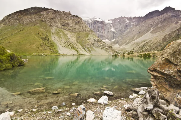 Lago di montagna blu riflette alte rocce — Foto Stock