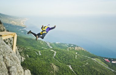 base-jumper jumps from the cliff clipart