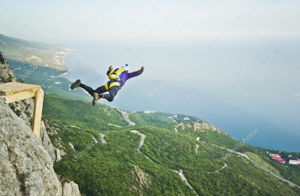 base-jumper jumps from the cliff