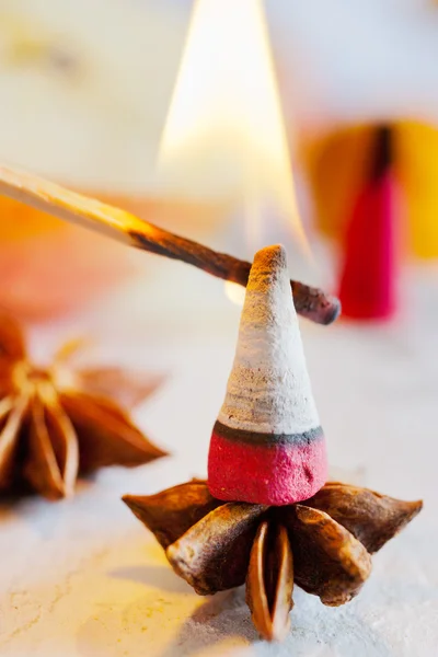 Traditional Czech christmas - smoking incense cones on star anise spice with whole cinnamon and apple — Stock Photo, Image