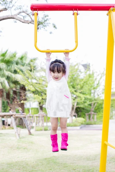 Little asian girl hang the bar in the playground — Stock Photo, Image