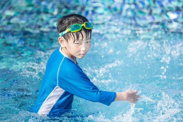 Little asian boy play in the pool with swimming suit — Stock Photo, Image