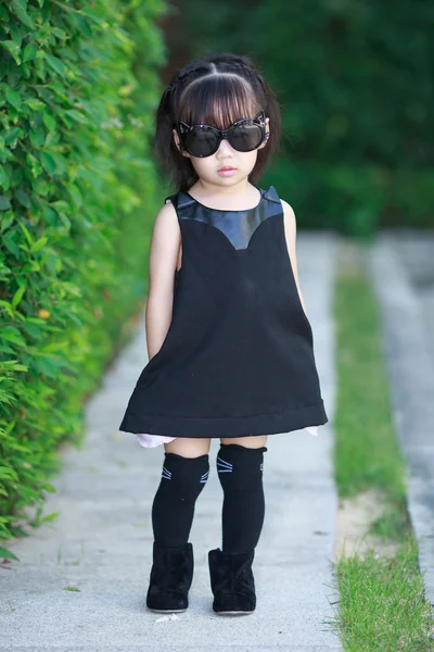 Little asian girl with sunglasses in black dress — Stock Photo, Image