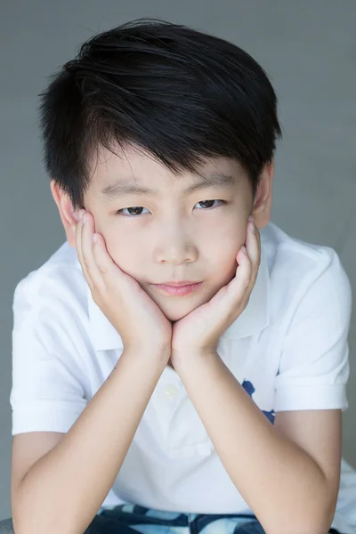 Pequeño asiático chico poner la cara en la mano —  Fotos de Stock