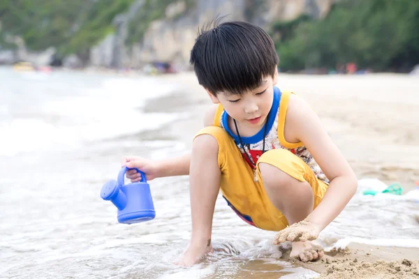 Little asian boy play sand on the beach — Stock Photo, Image