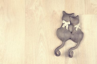 clay toy cats on  a wooden background clipart